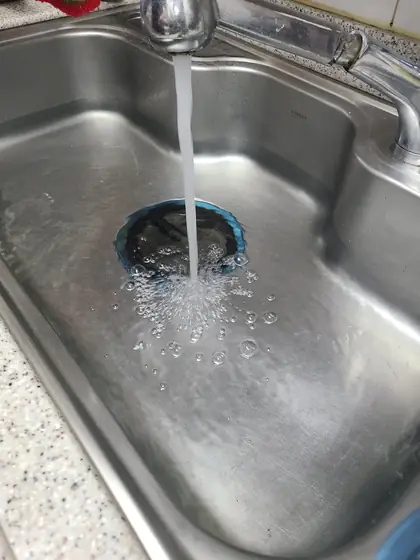 싱크대 배수통 물때 — 물을 틀어 새 배수통으로 내려가는지 보는 모습